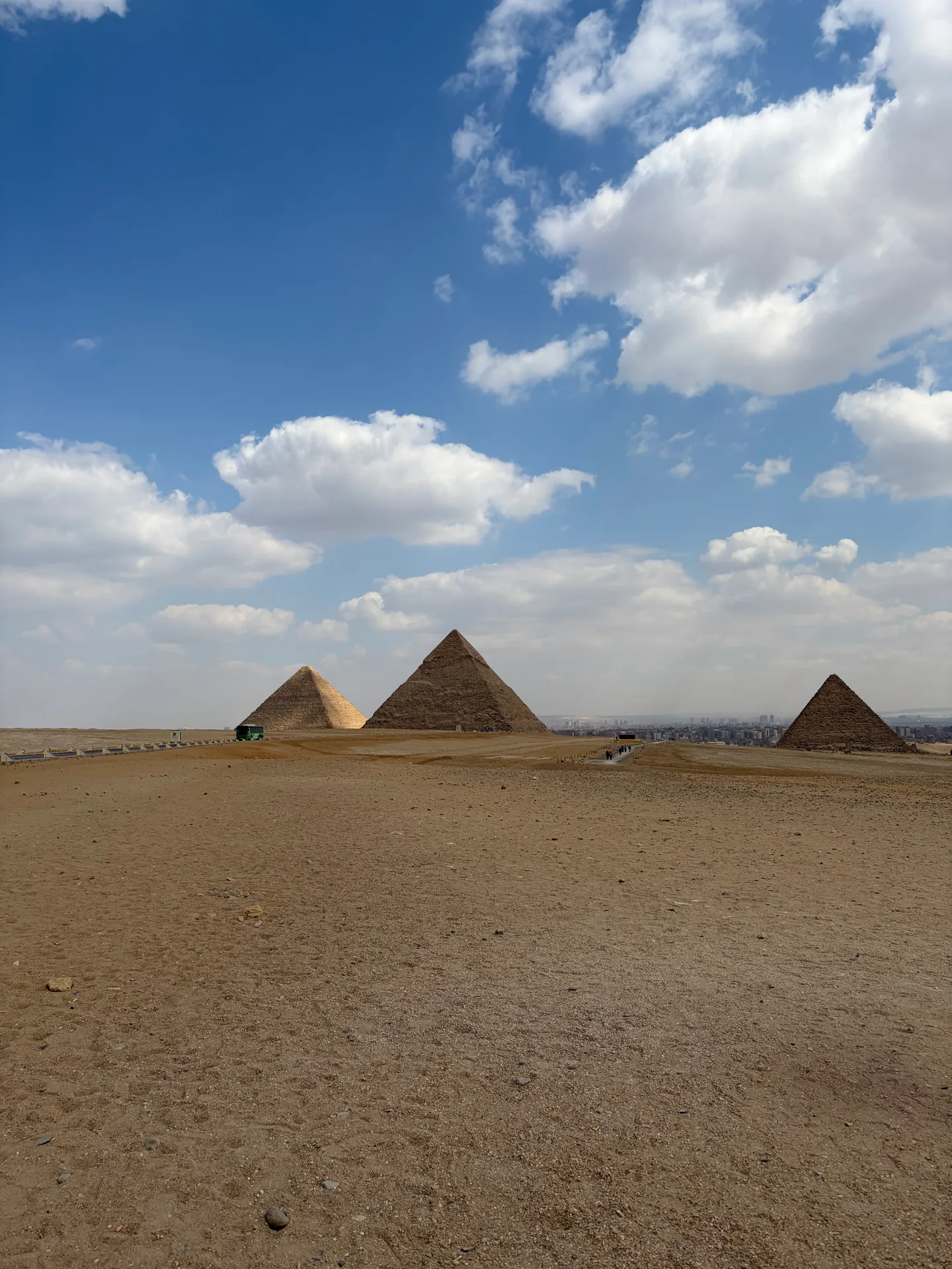 Panoramic view of the Giza pyramids beneath a blue sky
