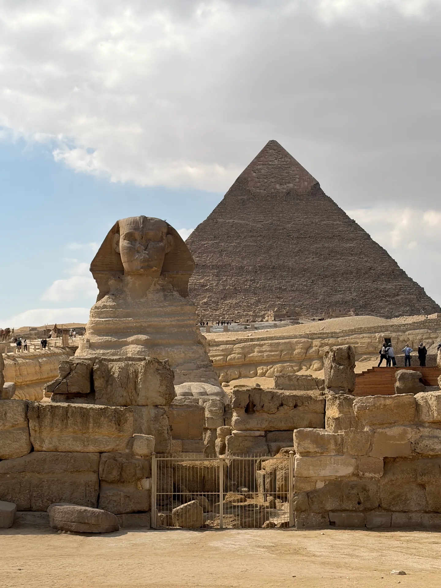 The Great Sphinx with a pyramid in the background