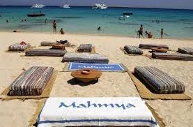 Mahmya-branded beach loungers facing the turquoise water