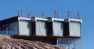 Ozirea Island beachfront suites beneath a clear blue sky