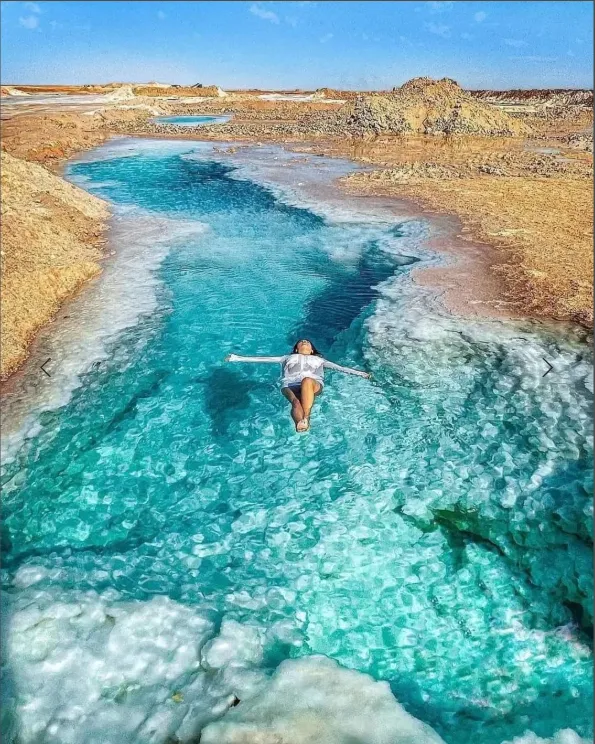 Aerial view of a swimmer in a Siwa Oasis salt pool