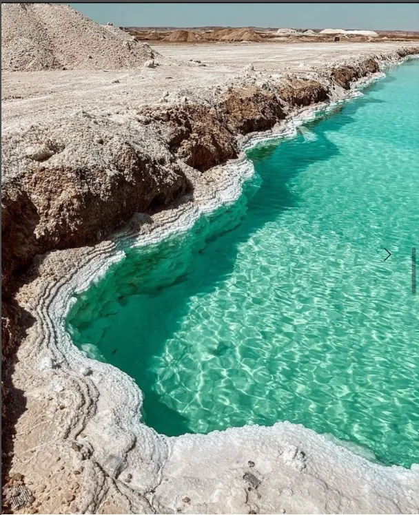 Clear blue salt pool among the Siwa desert rocks