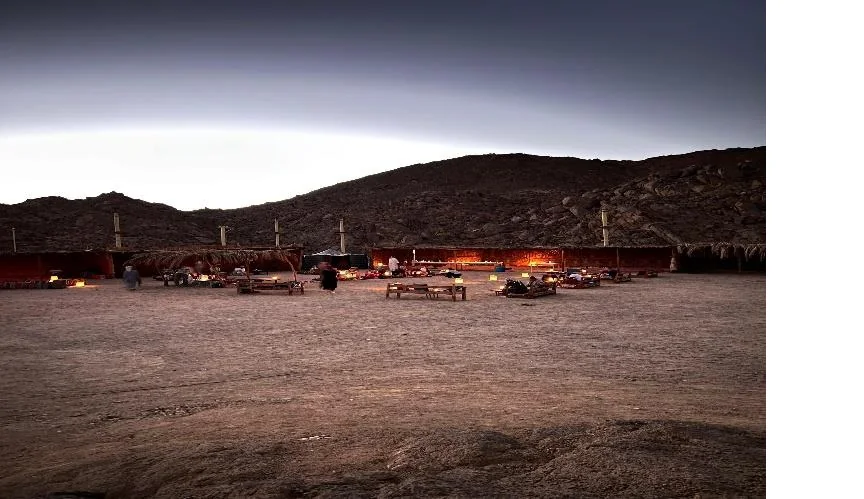 Desert mountain camp illuminated after dark