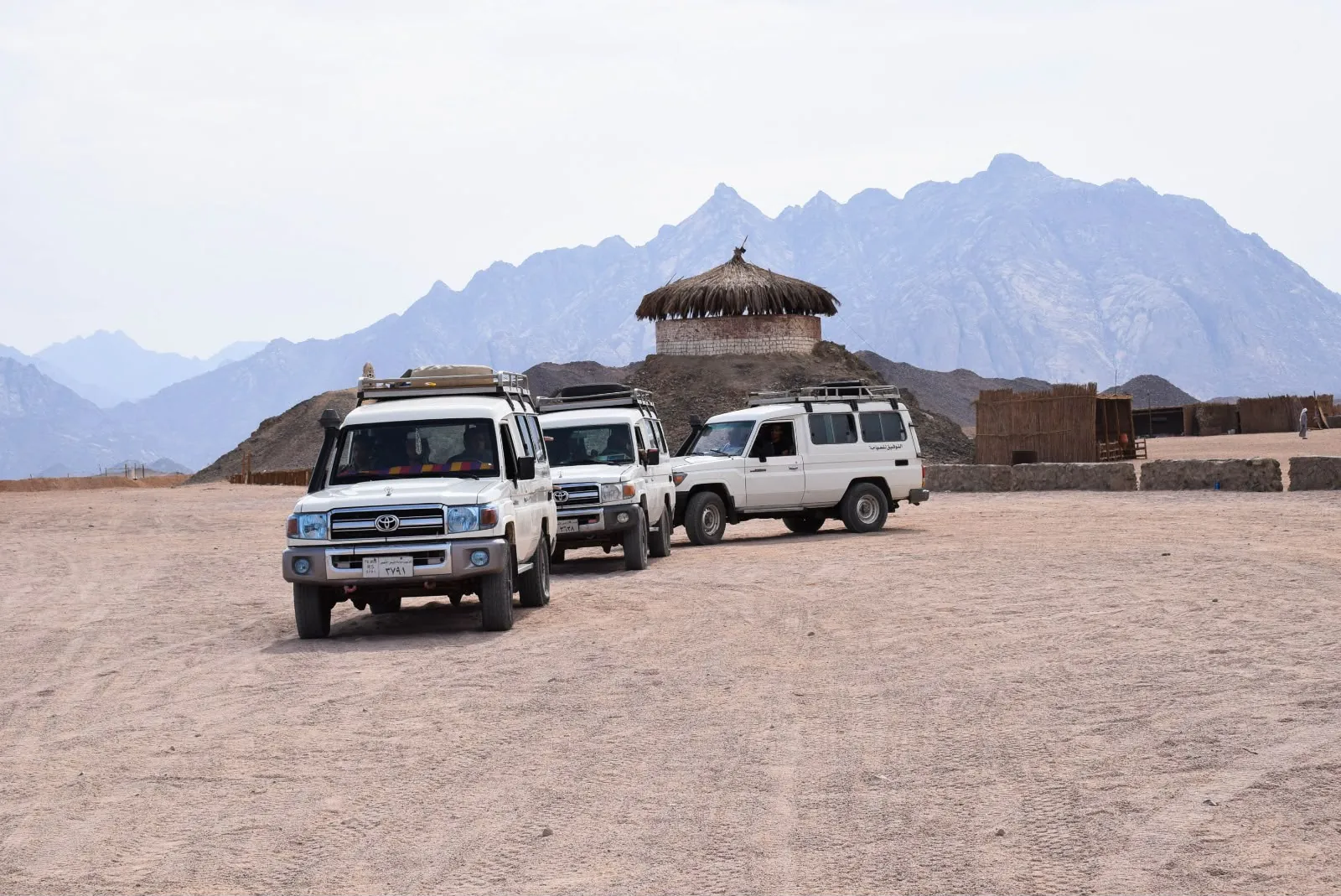 Four-wheel-drive vehicles crossing the desert safari route
